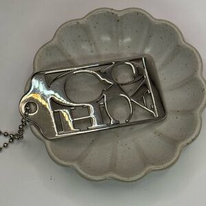 Coach metal script signature tag silver